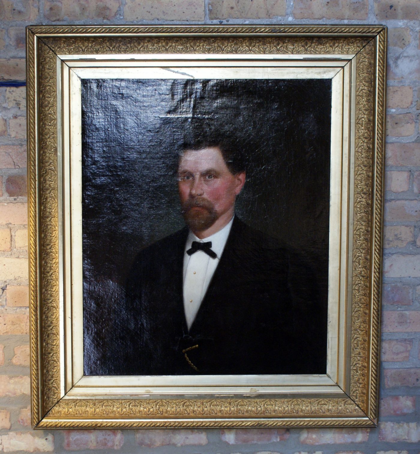 Portrait of Man Wearing Bow Tie in Gold Frame