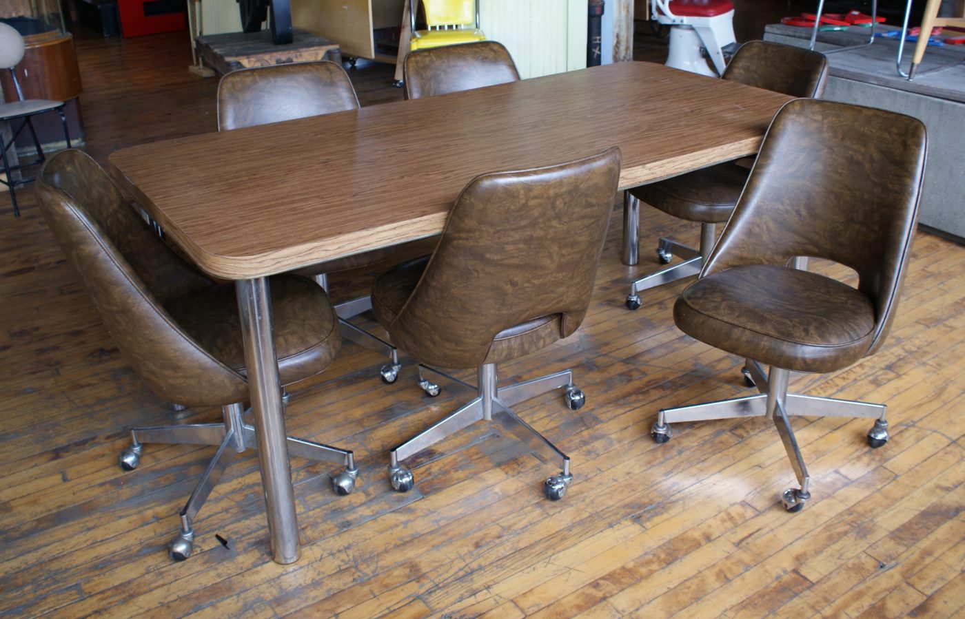 Laminate Top Table w Chrome Legs and 6 Brown Vinyl Rolling Chairs